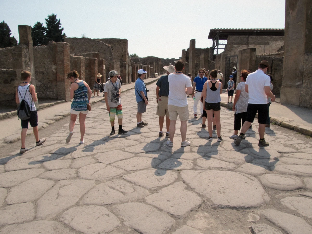 A large tour group crossing the Pompeii excavations - the megaphone format private tours avoid