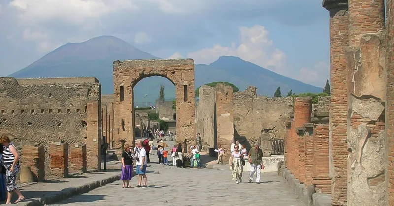 Archaeologist guide leading a three-hour private tour along a stepped ancient street in Pompeii